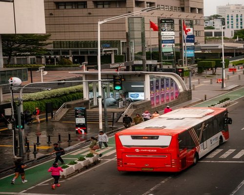 Commuters walking near a TransJakarta bus stop or MRT station in Jakarta